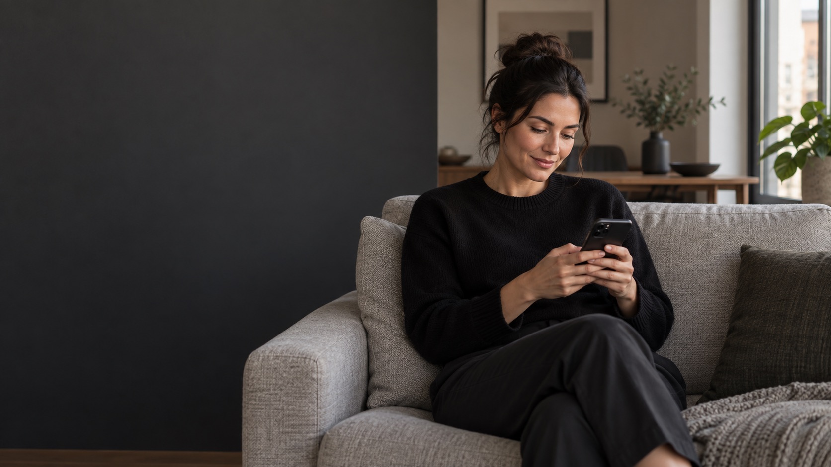 A woman relaxing at home with her phone